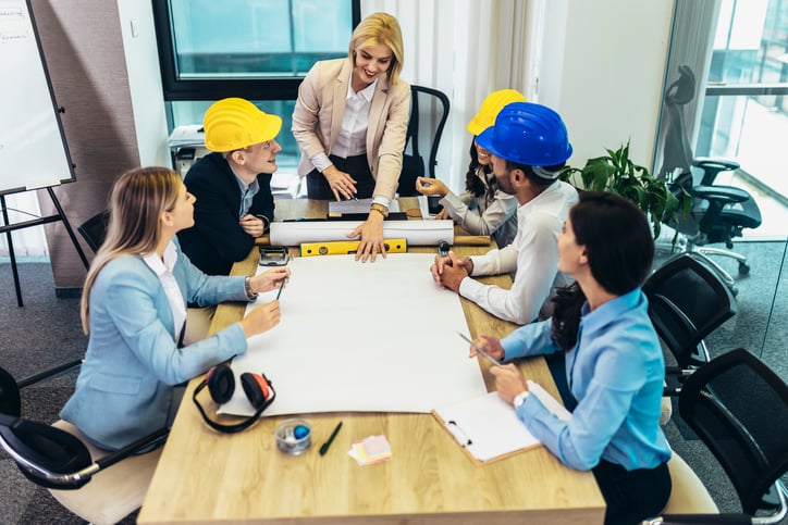 Architects, designers and engineers having working meeting in modern office