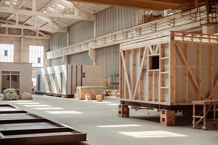 Building under construction with prefabricated containers and cabins