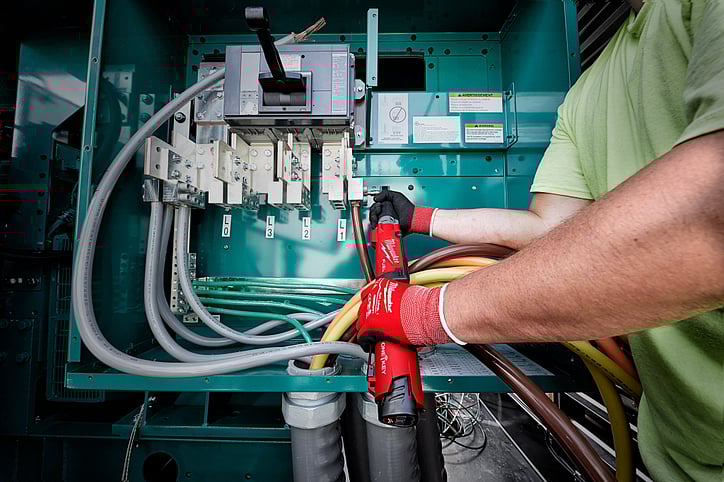 Electrical contractor using Milwaukee digital torque wrecnh installs fastener in electrical box