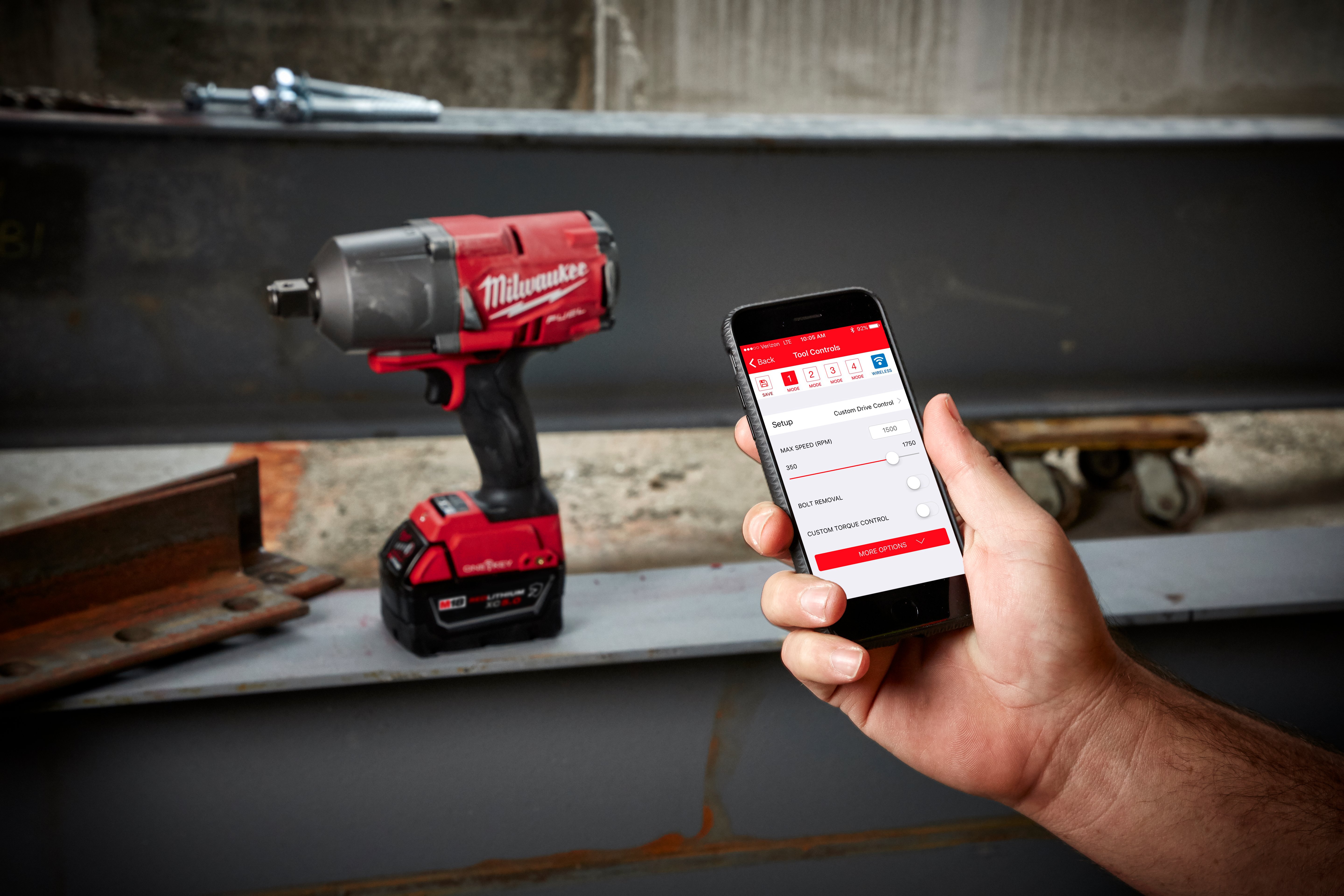 End user with One-Key app on smart phone adjusting max speed on impact wrench