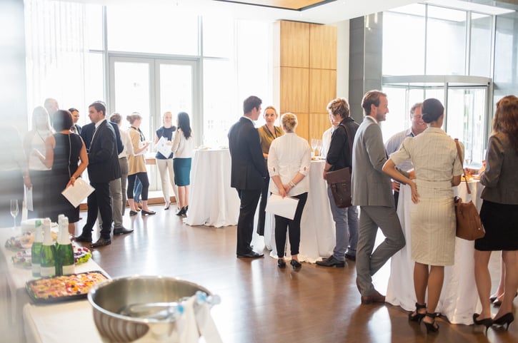 Group of conference participants standing in lobby of conference center