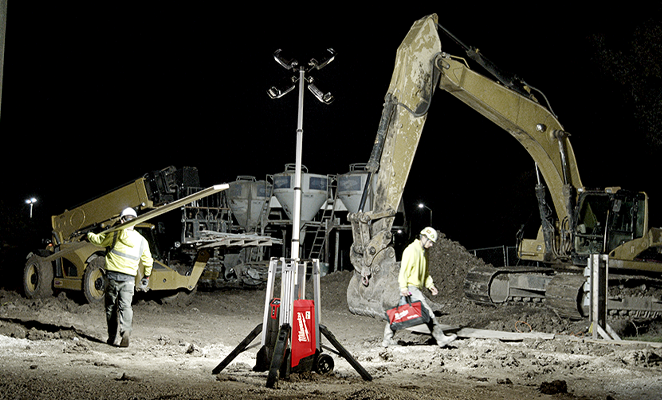 A jobsite, where tradesmen are at work, at dark, illuminated by a Milwaukee rocket tower light