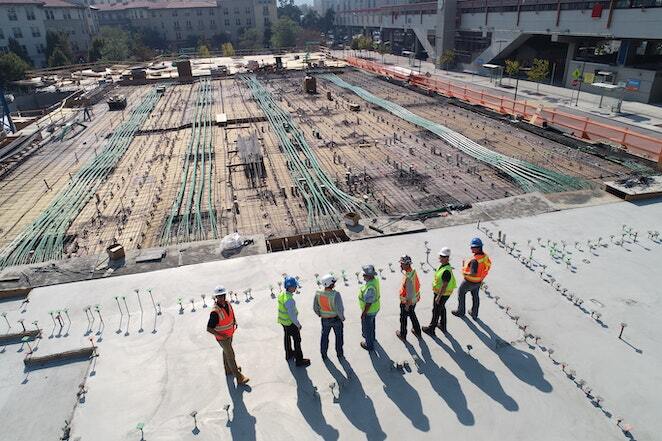 7 construction workers gather on jobsite