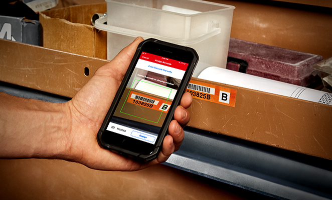 smartphone camera scans a barcode on a warehouse item