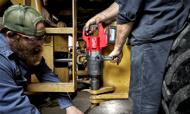 Image shows two men tradesmen on jobsite completing work with Milwaukee d-handle high torque impact wrench