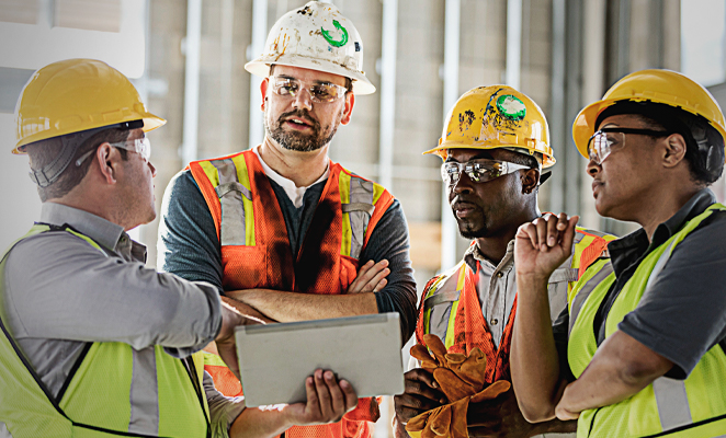 A construction project management team confers together