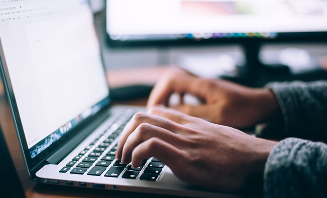 A laptop computer is open to a Google document