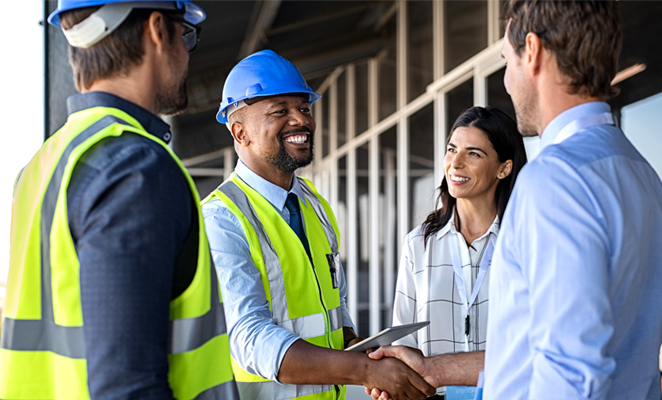 Two contractors meet two clients, shaking hands