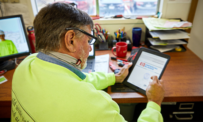 A tool room attendant views project details on iPad