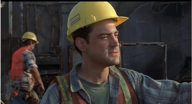 Peter Gibbons from Mike Judge's 1999 Office Space on construction site in high visibility vest and yellow hard hat