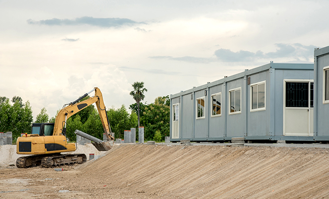 A crane beside temporary classroom buildings