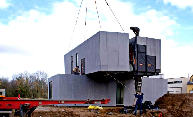 Construction worker oversees installation of prefabricated modules