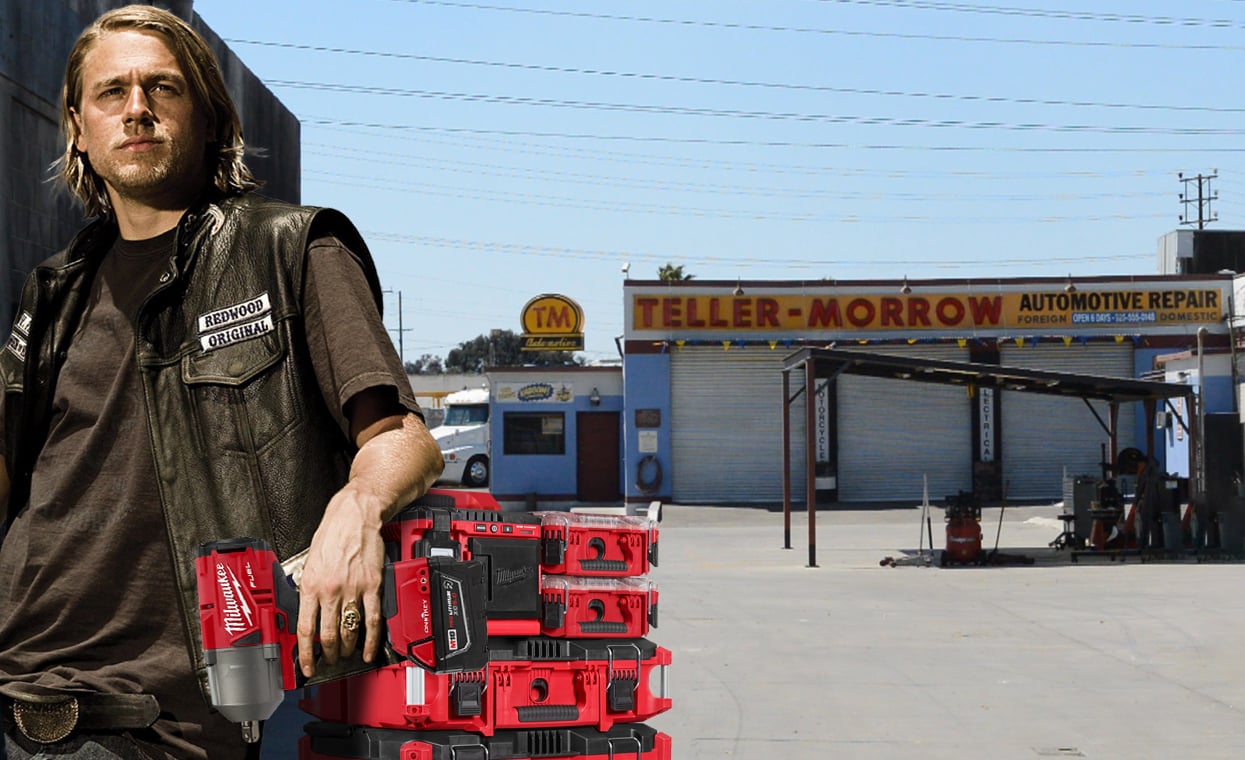 Jax Teller stands beside PACKOUT modular storage holding impact gun in front of Teller-Morrow garage
