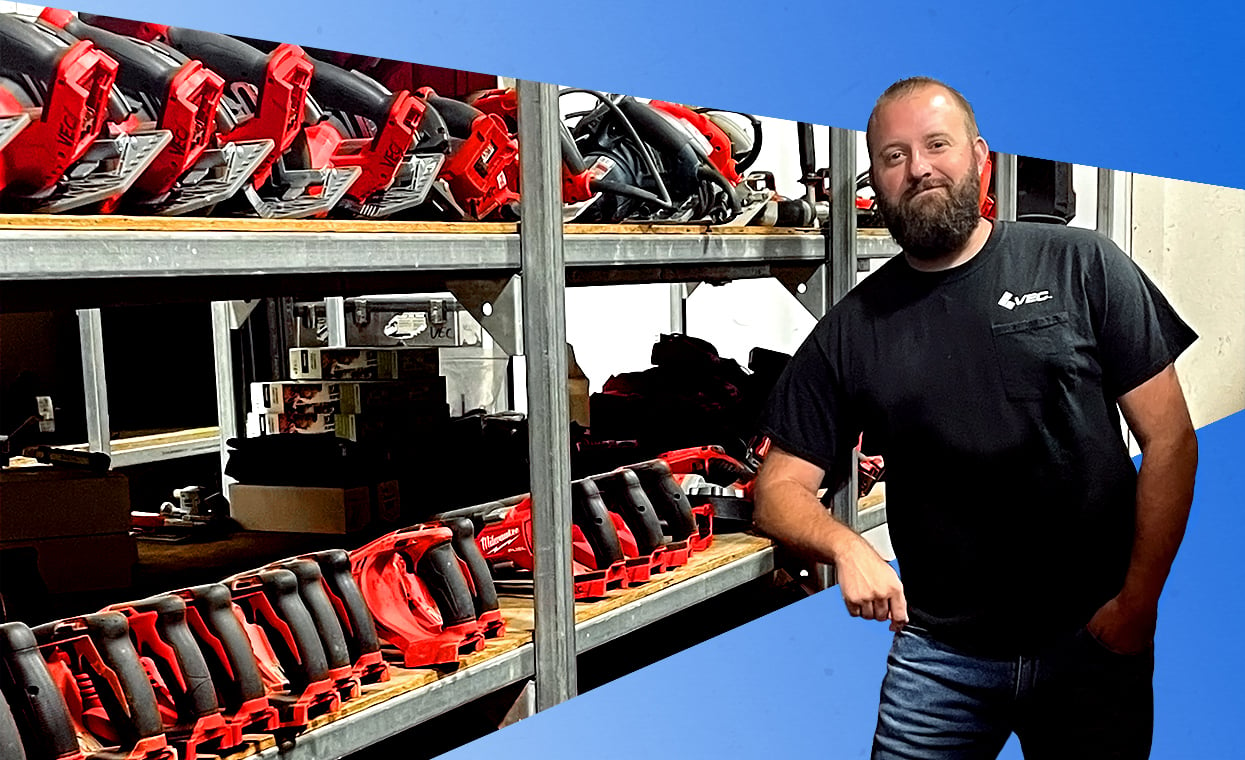 Image of Josh Patrick, field services director for VEC Inc., leaning against a rack of Milwaukee power tools.