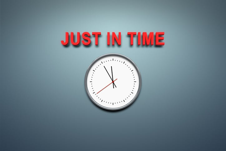 Just in time message sits above a ticking wall clock