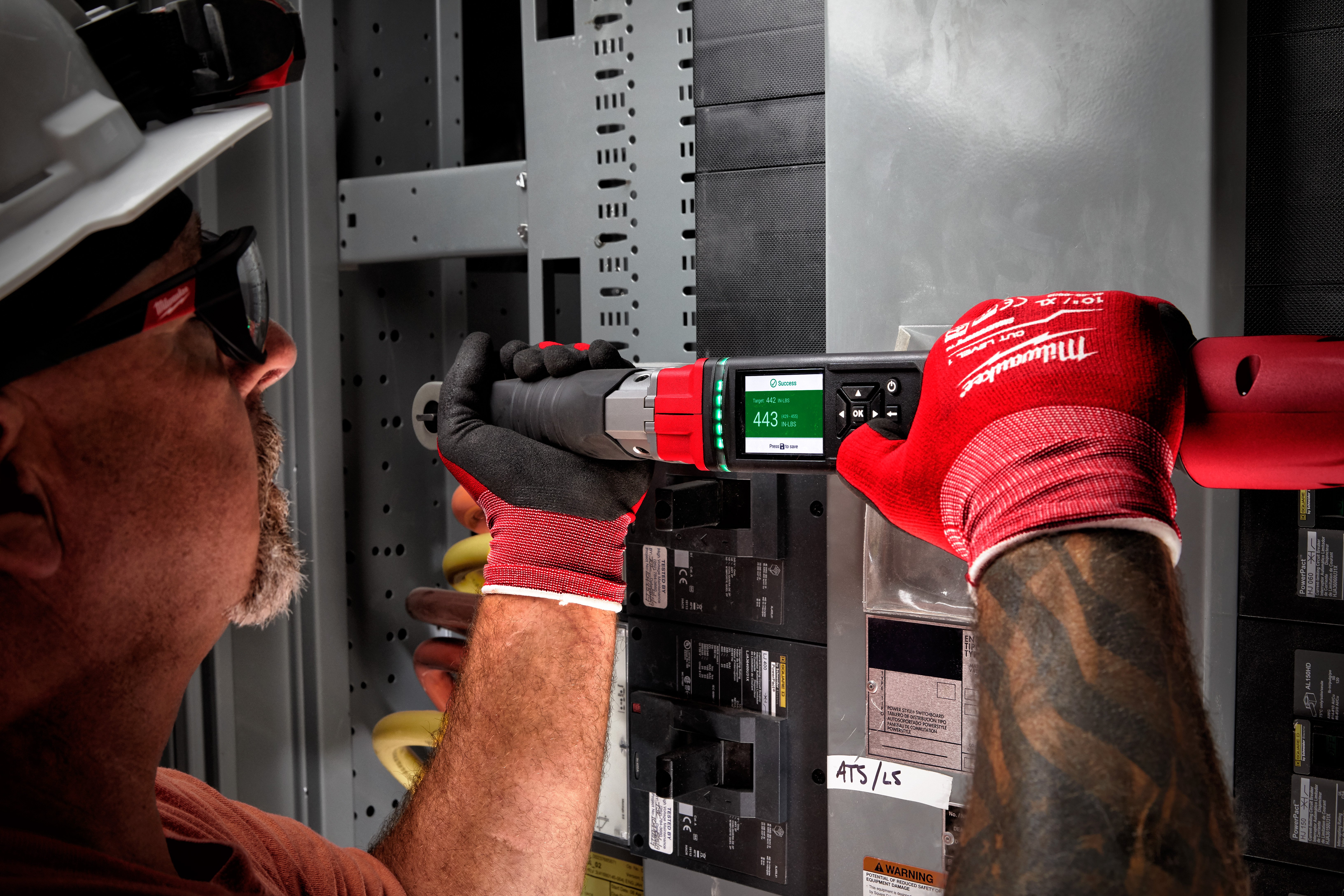 An electrical contractor uses a Milwaukee digital torque wrench to complete installation