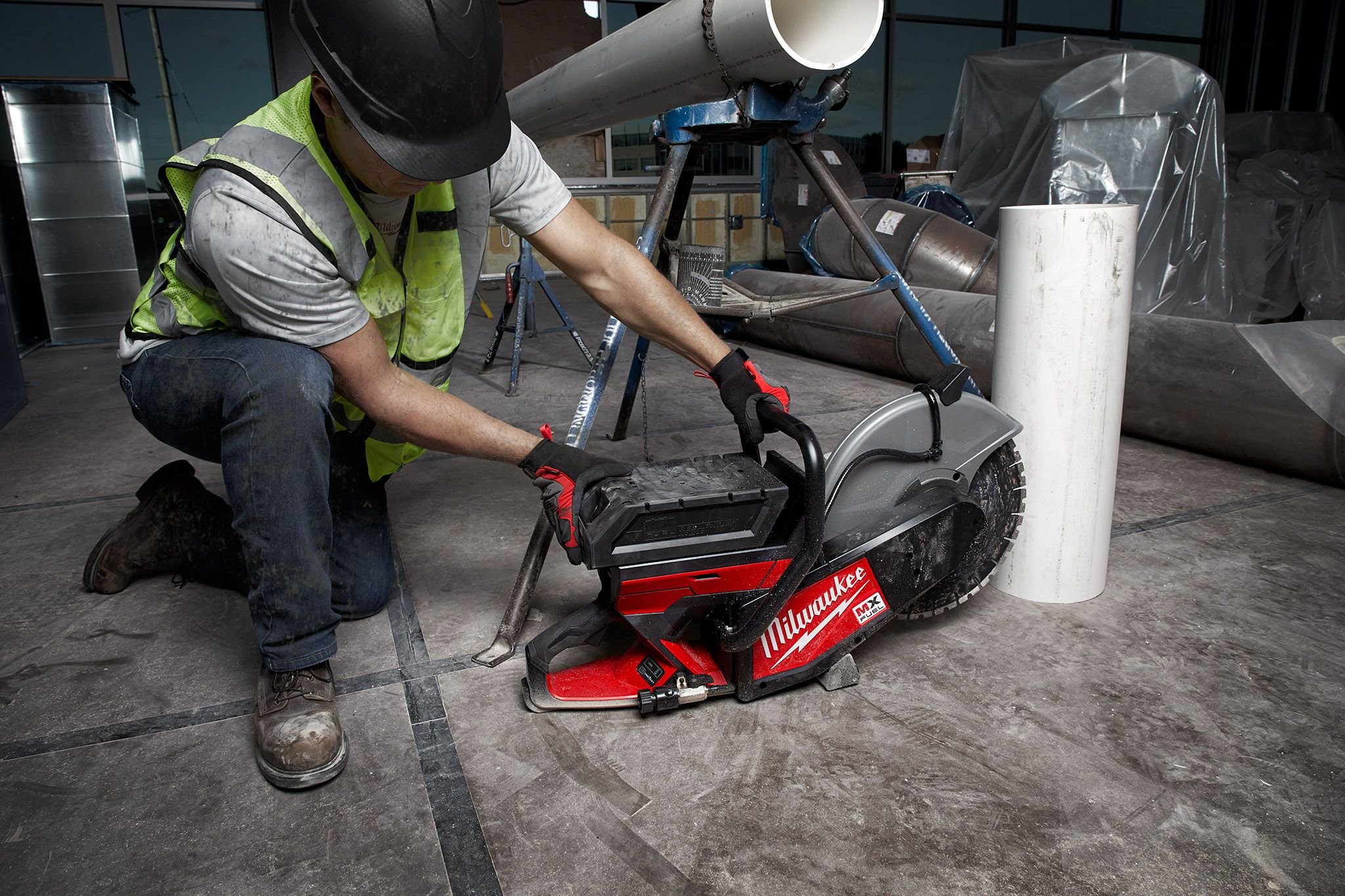 A concrete finisher uses MX FUEL Cut Off Saw to cut out section in floor