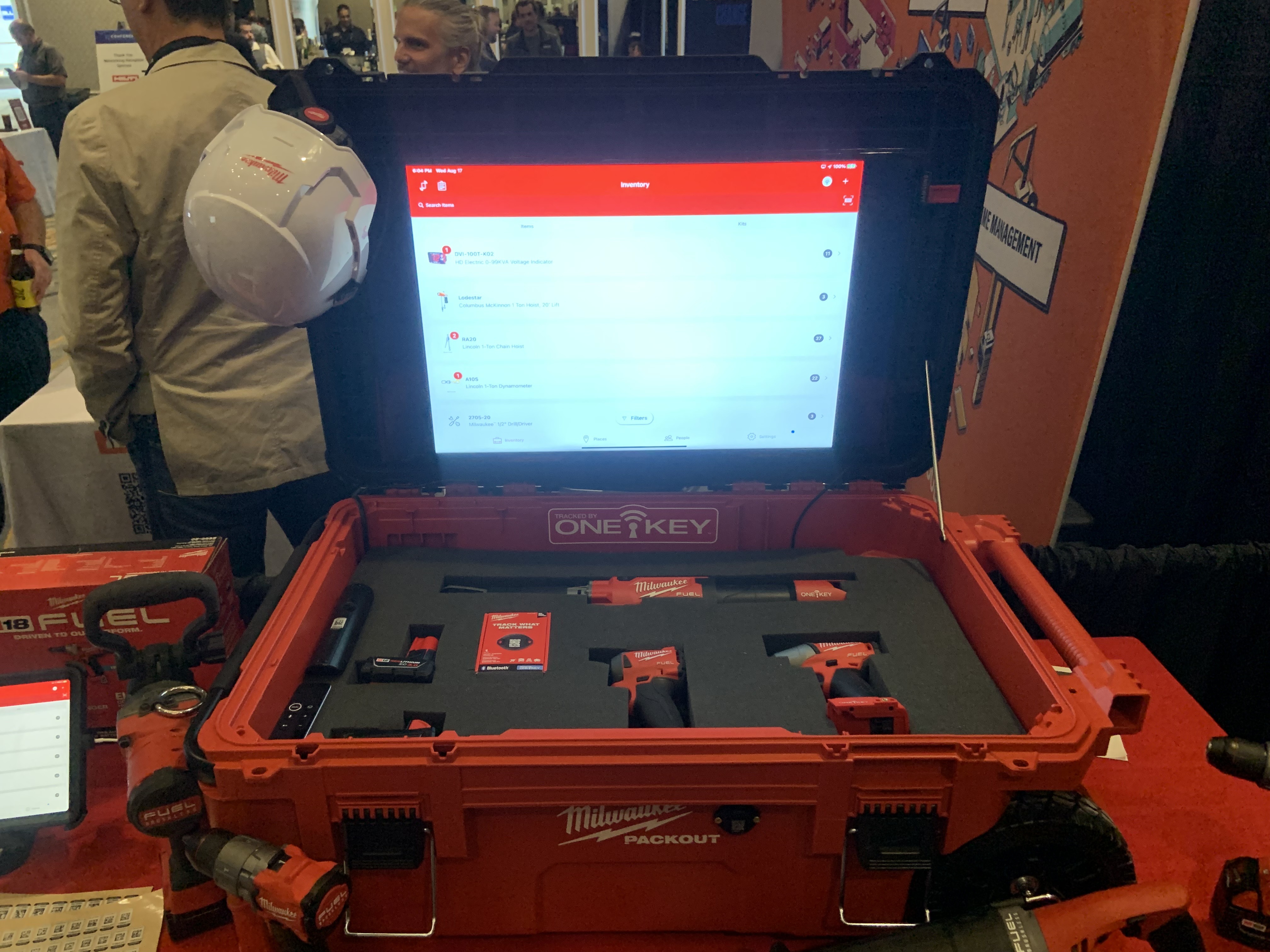 One-Key displayed on monitor of open booth-in-a-box with Milwaukee Tool products
