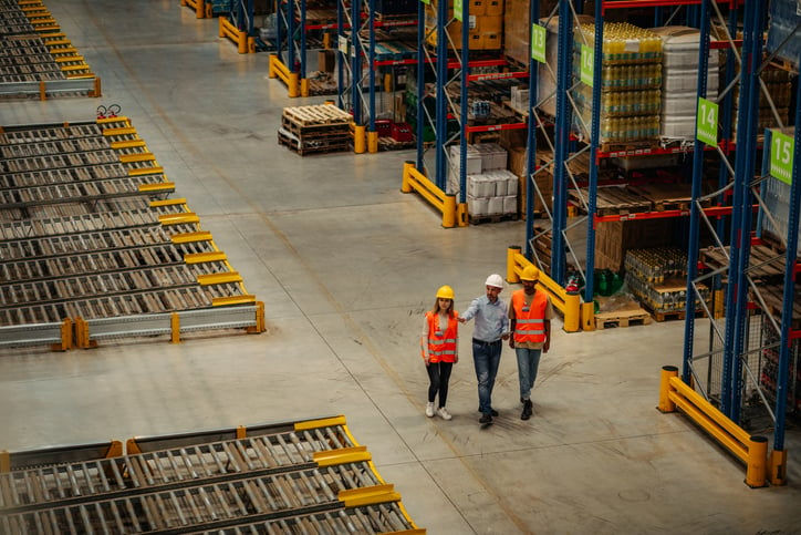 Prefab warehouse coworkers meeting with supervisor