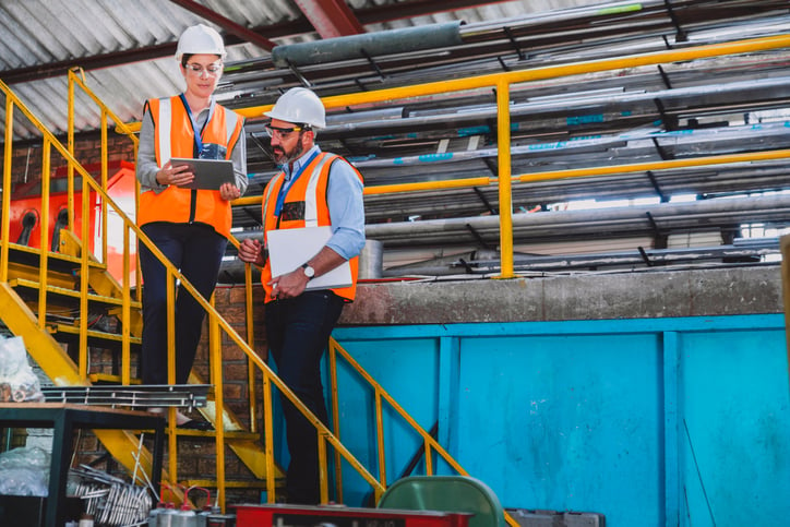 Project manager consults with business owner on construction jobsite