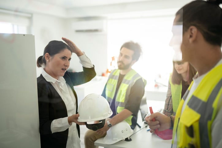 Safety manager conducting training with construction workers