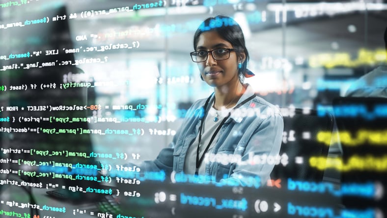 Software engineer looking at whiteboard with code overlay