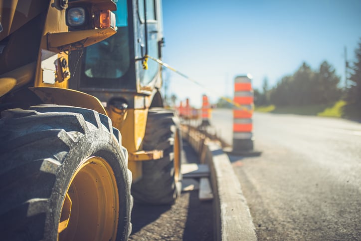 Yellow-tractor-beside-highway-coonstruction-project