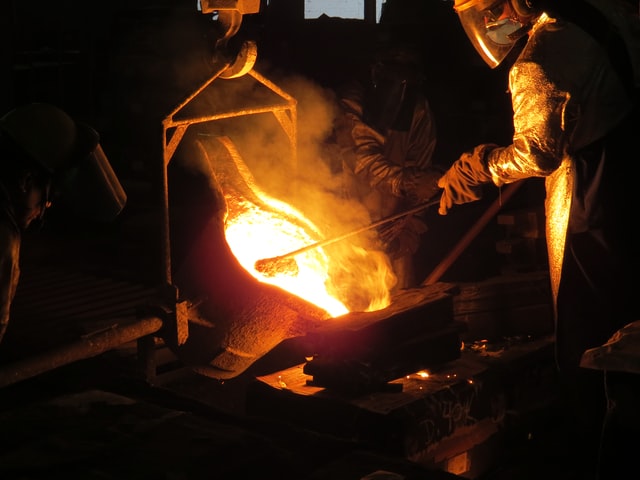 A blacksmith forges tool in fire