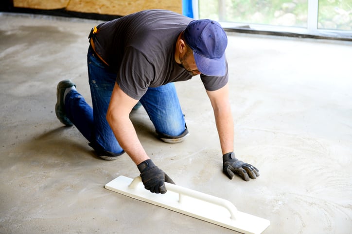 A contractor installs a cement floor