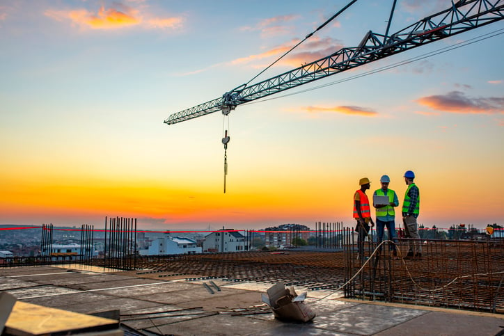 construction workers at sunset