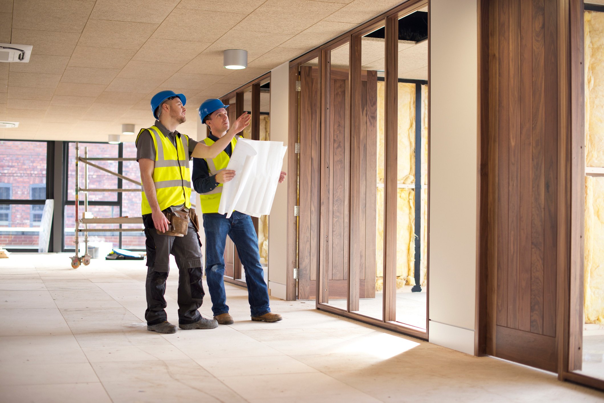 Two construction and building inspectors examine jobsite