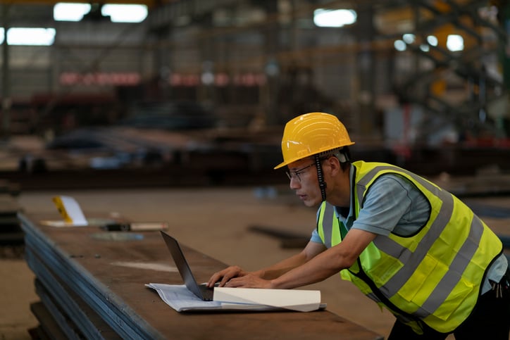 construction-worker-in-field-on-laptop