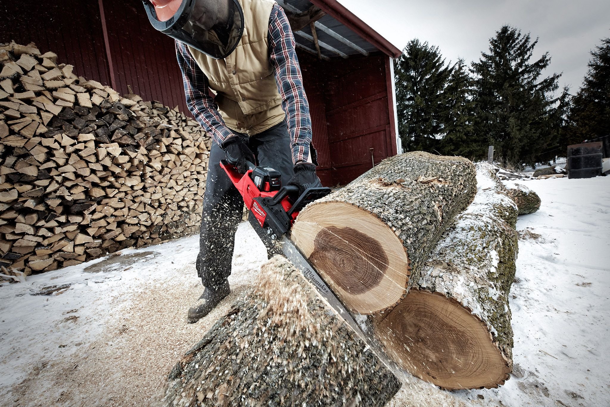 A Milwaukee battery-powered chainsaw used to cut down a tree