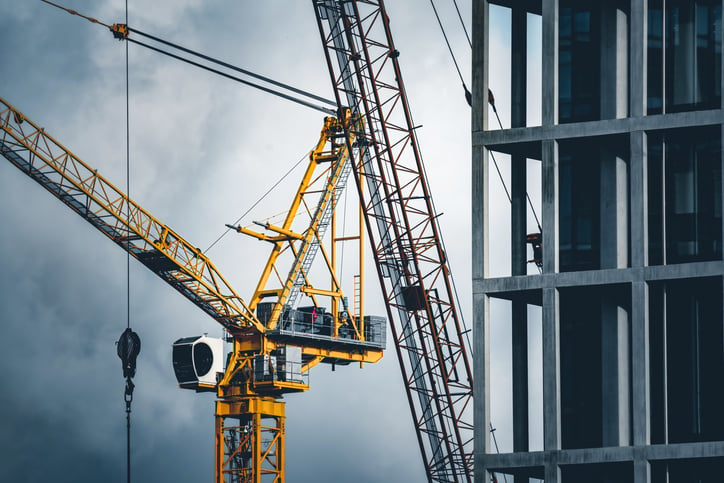 crane beside housing skyrise