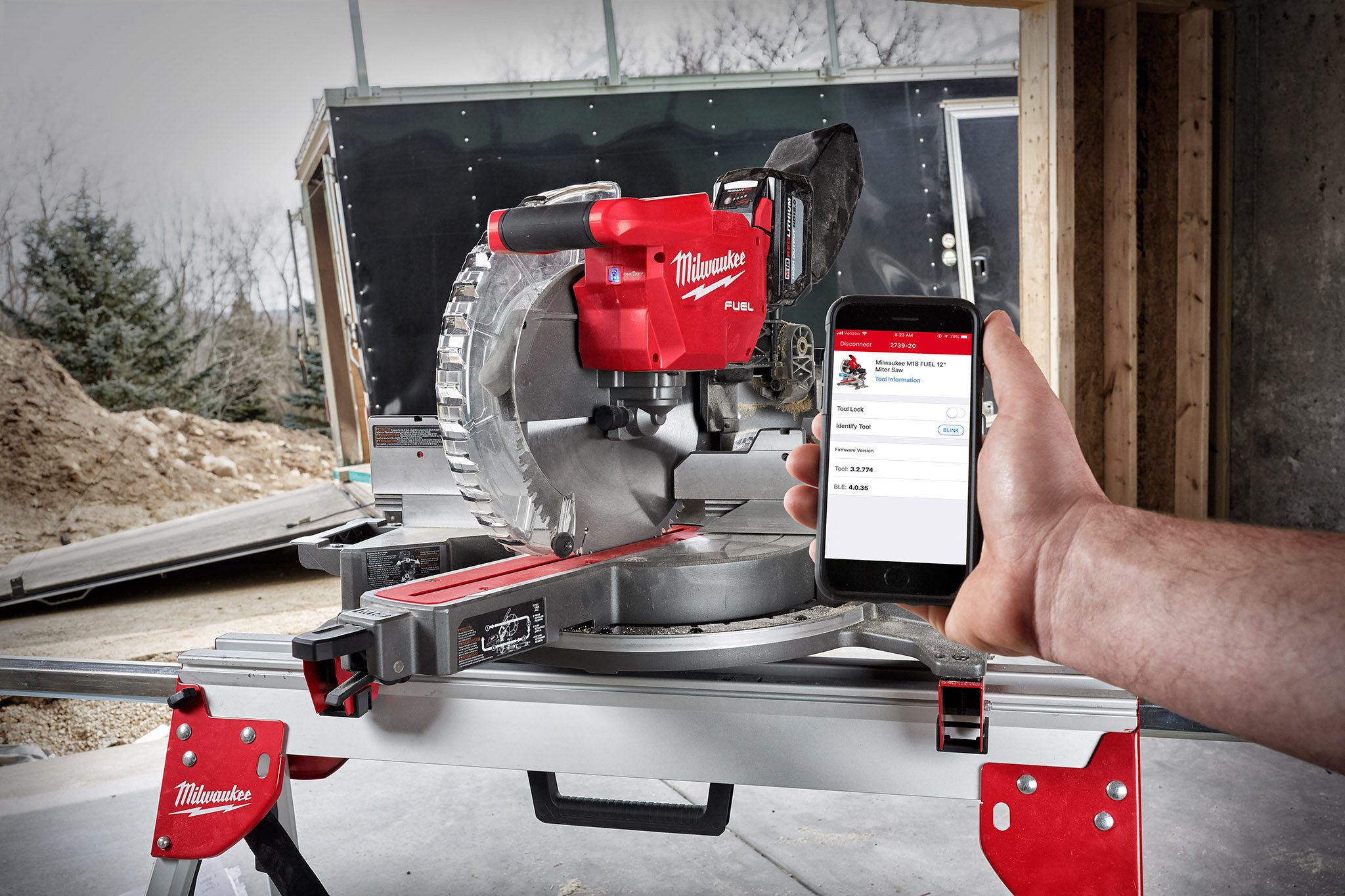 A woodworking professional uses smartphone to connect to his One-Key compatible miter saw