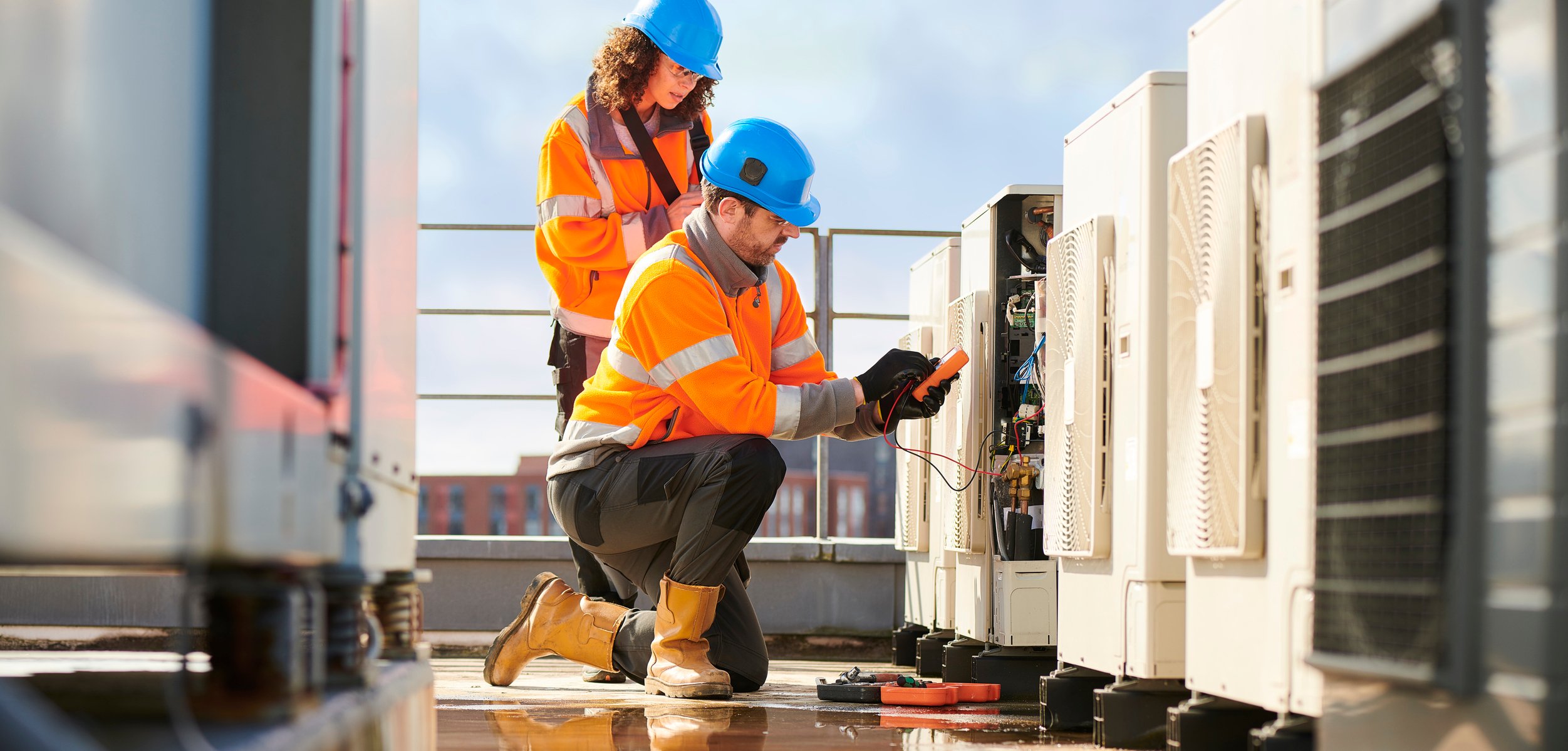 electricians-repairing-ac-unit