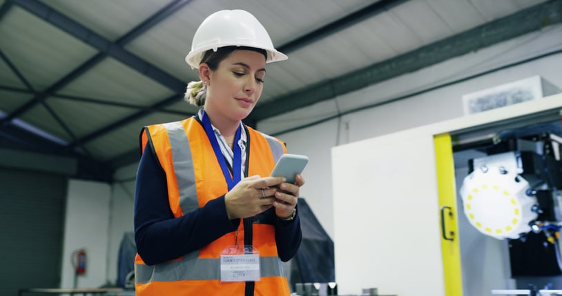 female-construction-worker-holding-phone