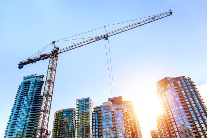 Construction crane shot from below at sunrise.