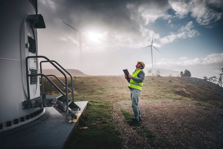 wind turbine technician gazing up