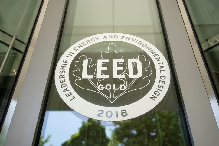 A photo of a LEED gold certification decal on a glass window.