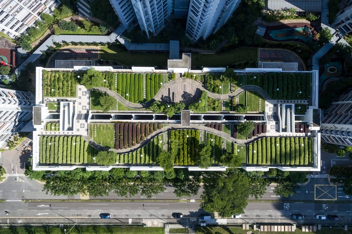 Top down aerial view of a building with a green roof.