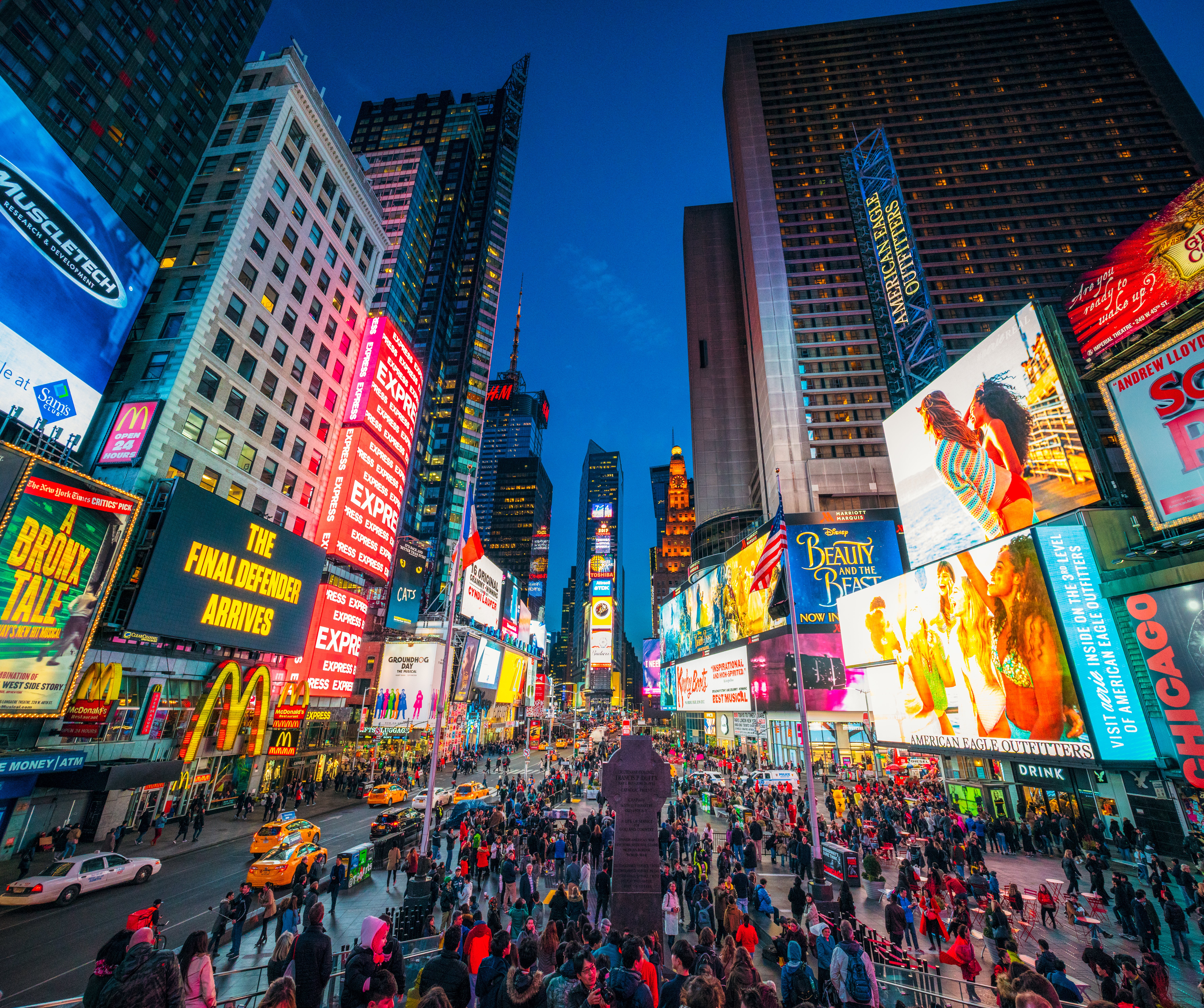 A night photograph of Times Square in New York City,
