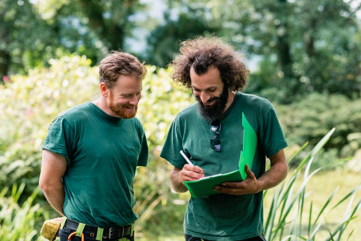 landscape discuss plans in green clipboard