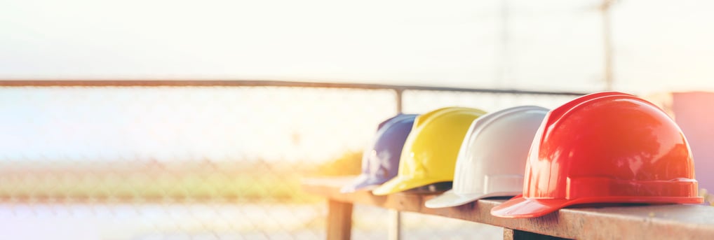 line of hard hats on bench