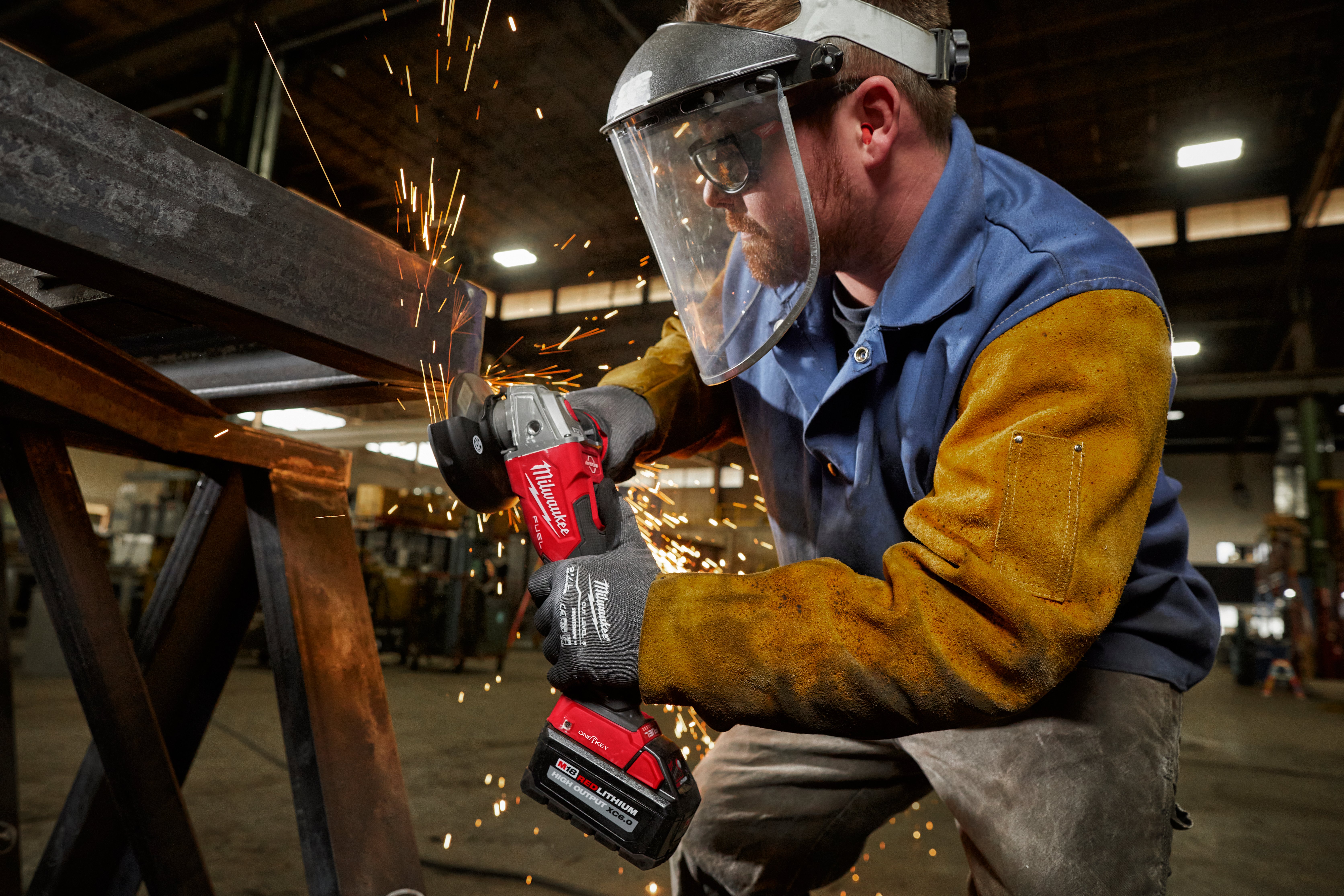 A metalworker utilizes a Milwaukee grinder that is compatible with the One-Key app