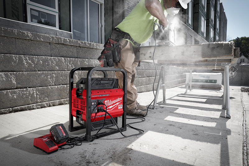 MX FUEL™ battery-powered CARRY-ON™ power supply powers contractor’s circ saw and M18™ charger beside it