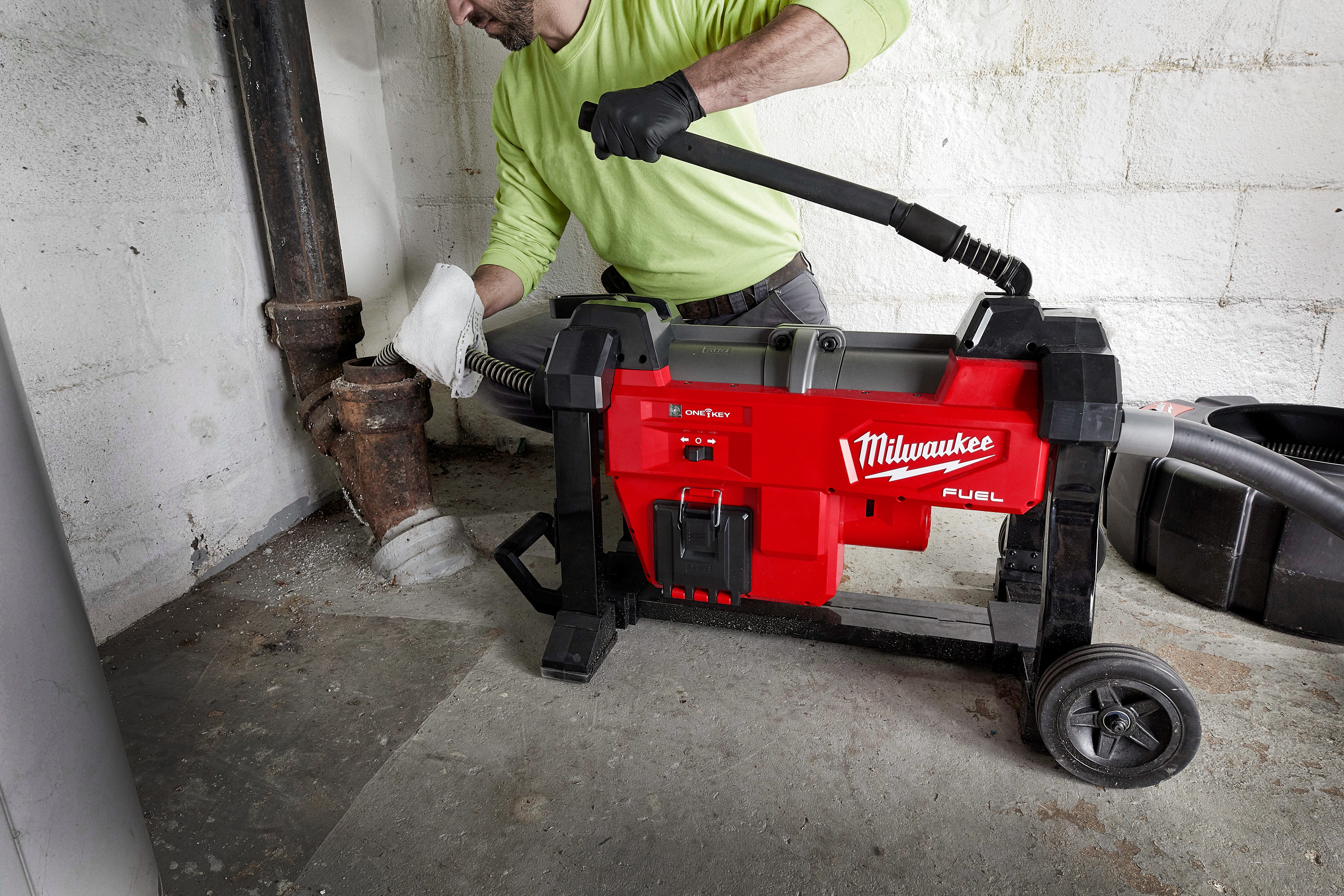 A drain cleaning professional utilizes a Milwaukee sectional drain cleaning machine