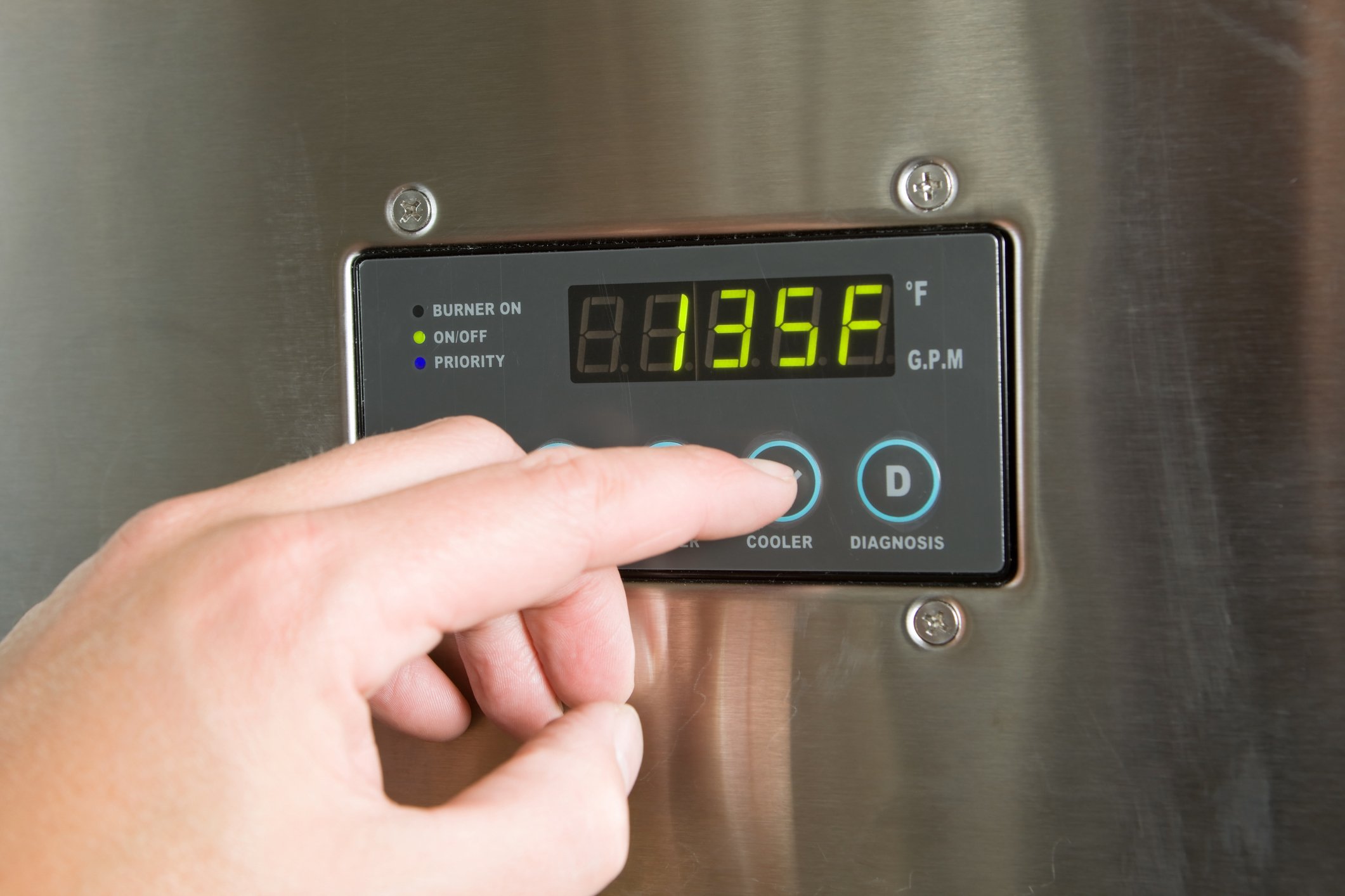 A homeowner utilizing the control panel on a tankless water heater