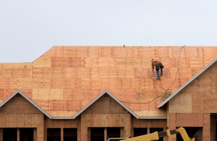 A roofer prepares roof for shingle installation