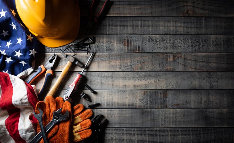 veteran flag next to handful of tools and hardhat